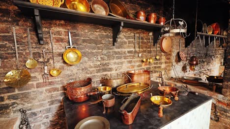 Old European castle kitchen with rustic cookware, copper vessels, and warm tones