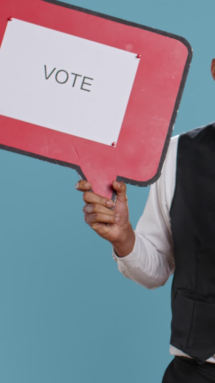 Person Holding 'VOTE' Sign for Election Participation