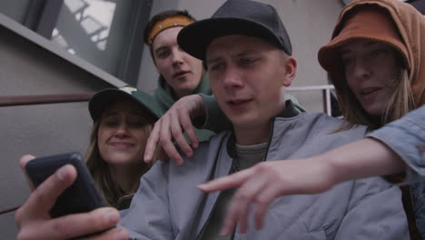 friends using smartphone on the stairs