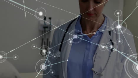 animation of network of connections over caucasian female doctor using tablet