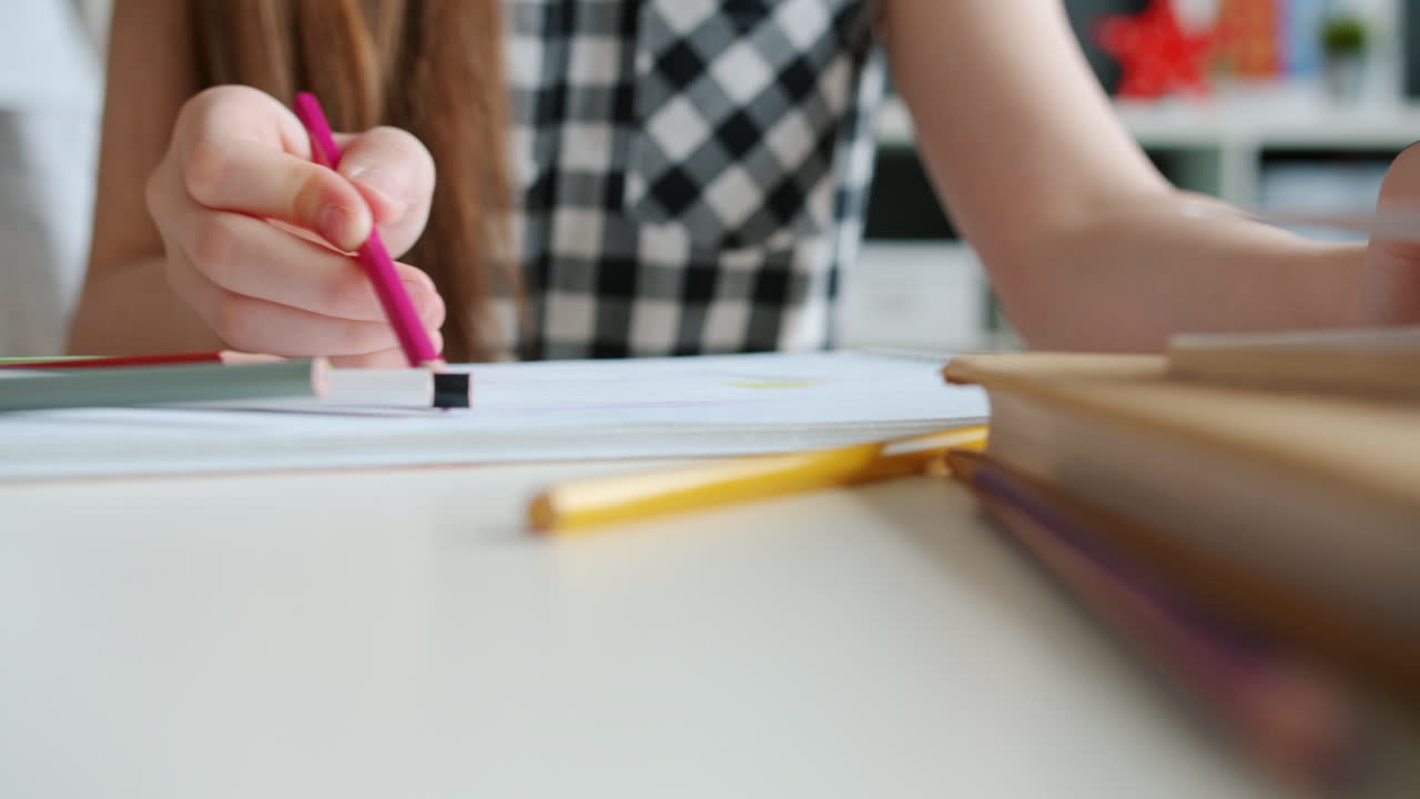 Girl drawing with colored pencils