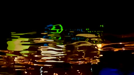 reflection of the clarke quay sign in the singapore river at night