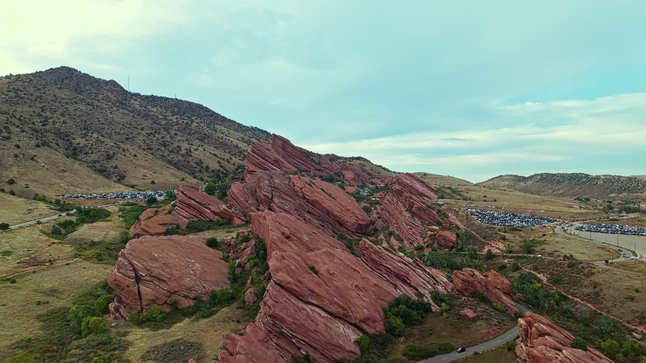 Massive red sandstone formations at Red Rocks Amphitheatre Colorado, scenic aerial establish