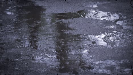 heavy rain shower downpour cloudburst rainfall behind the glass.