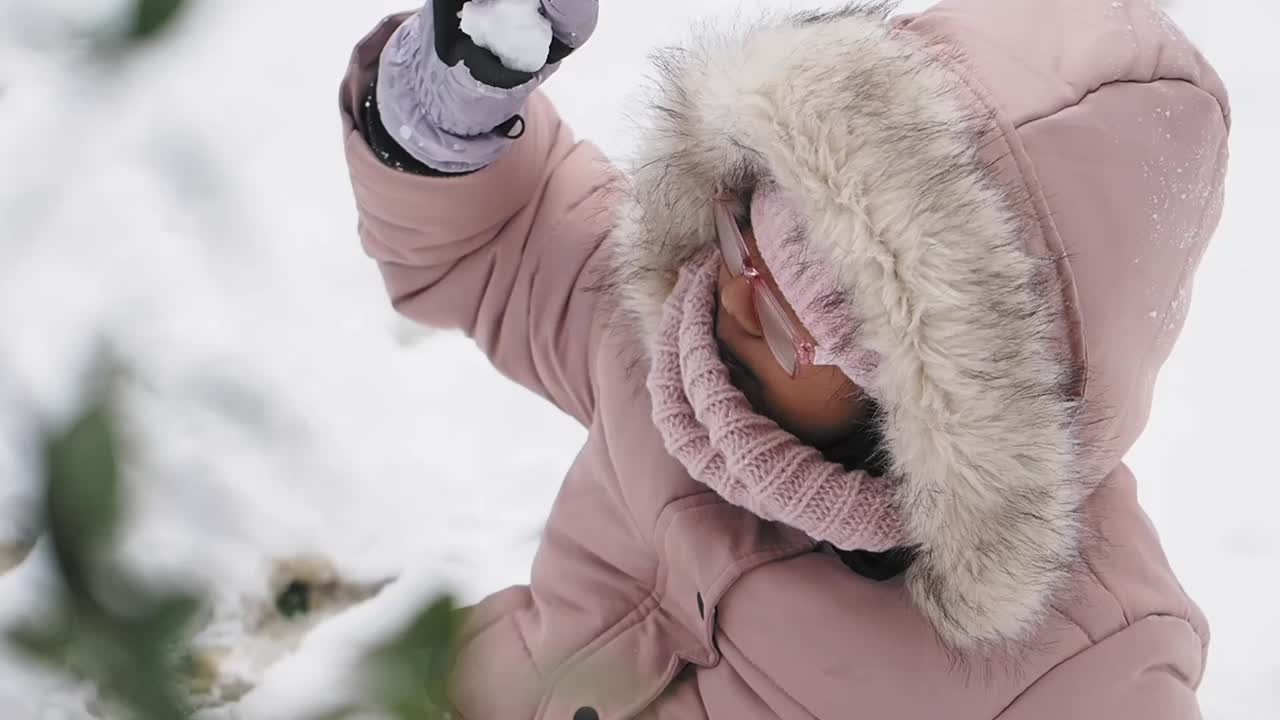Girl playing with snow in winter