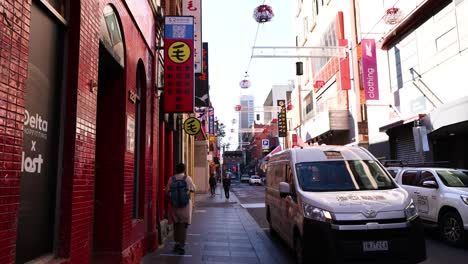 pedestrians and vehicles in chinatown, melbourne