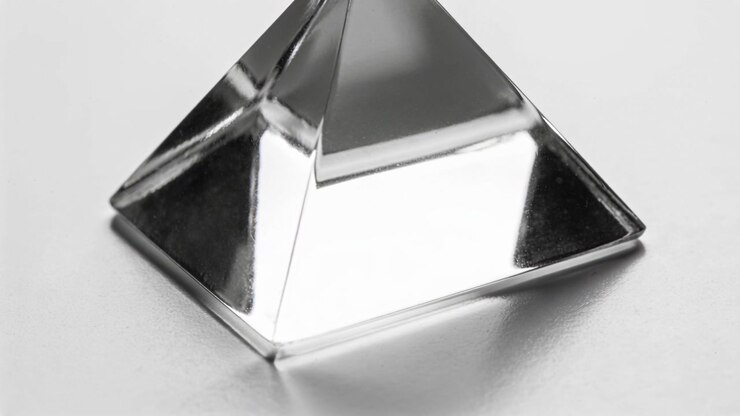 Frame sequence causing metallic pyramid sitting centered on white surface, showing specular shifts