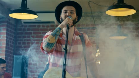 guitarist singing in smoke