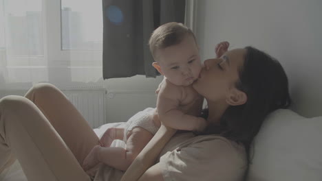 mom kissing and hugging her cute baby