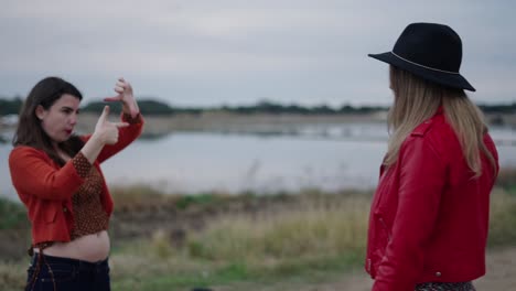two women having a conversation by a lake