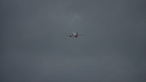 airplane is soaring through ominous storm clouds, highlighting the power of aviation against a moody sky