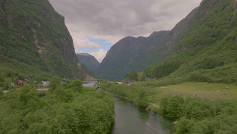 Gudvangen-Nordic-village-on-edge-of-NÃ¦rÃ¸yfjord-with-Gudvanga-Tunnel,-aerial