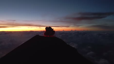 Cinematic-aerial-view-of-Fuego-volcano-erupting,-spewing-lava,-ash,-and-gases