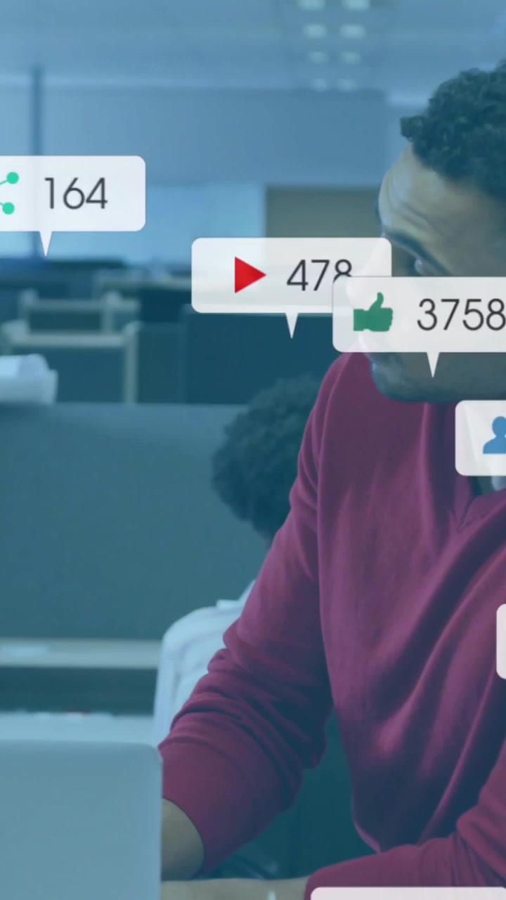 Vertical video: Man in red using laptop while alerts popping and overlaying him, tracking marketing