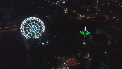 night aerial view of amusement park with ferris wheel