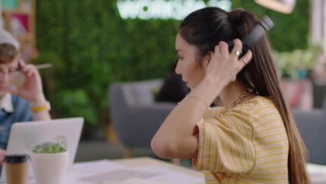 portrait-beautiful-young-asian-woman-student-smiling-happy-entrepreneur-enjoying-successful-career-listening-to-music-wearing-headphones-in-trendy-startup-office