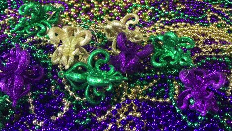 twinkling mardi gras ornaments and colorful beads