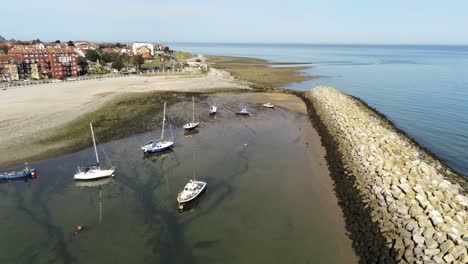 aerial view boats in shimmering low tide sunny warm rhos on sea seaside sand beach marina high to low