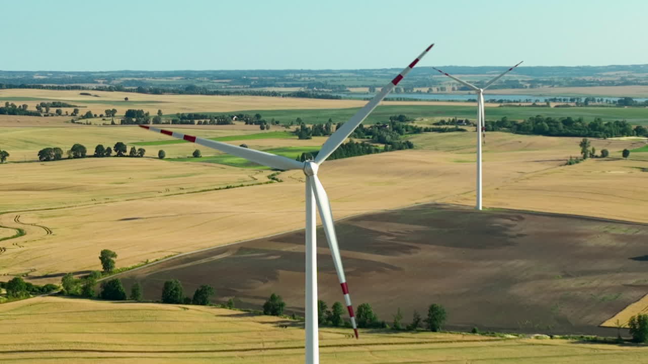 Wind Turbines in Rural Fields Under Blue Sky