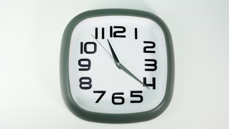 the white wall clock tells the time at 11 o'clock.