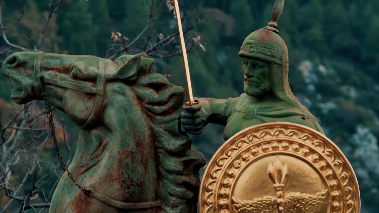 Eze, France - November 24, 2024: Bronze warrior statue at the top of a hill