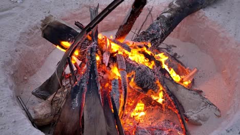 close up of bonfire at sandy beach for camping