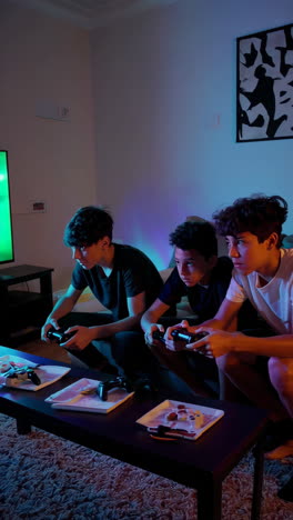 three boys playing video games together