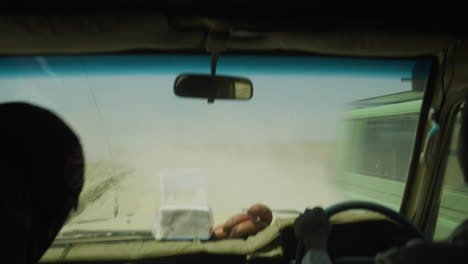 dusty roads of serengeti valley national park, with cars passing, tanzania