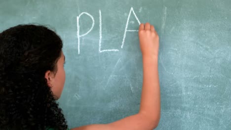 Attentive-schoolgirl-pretending-to-be-a-teacher-in-classroom
