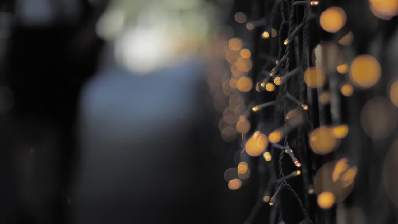 guys walking closed to camera outfocus on bridge during christmas season