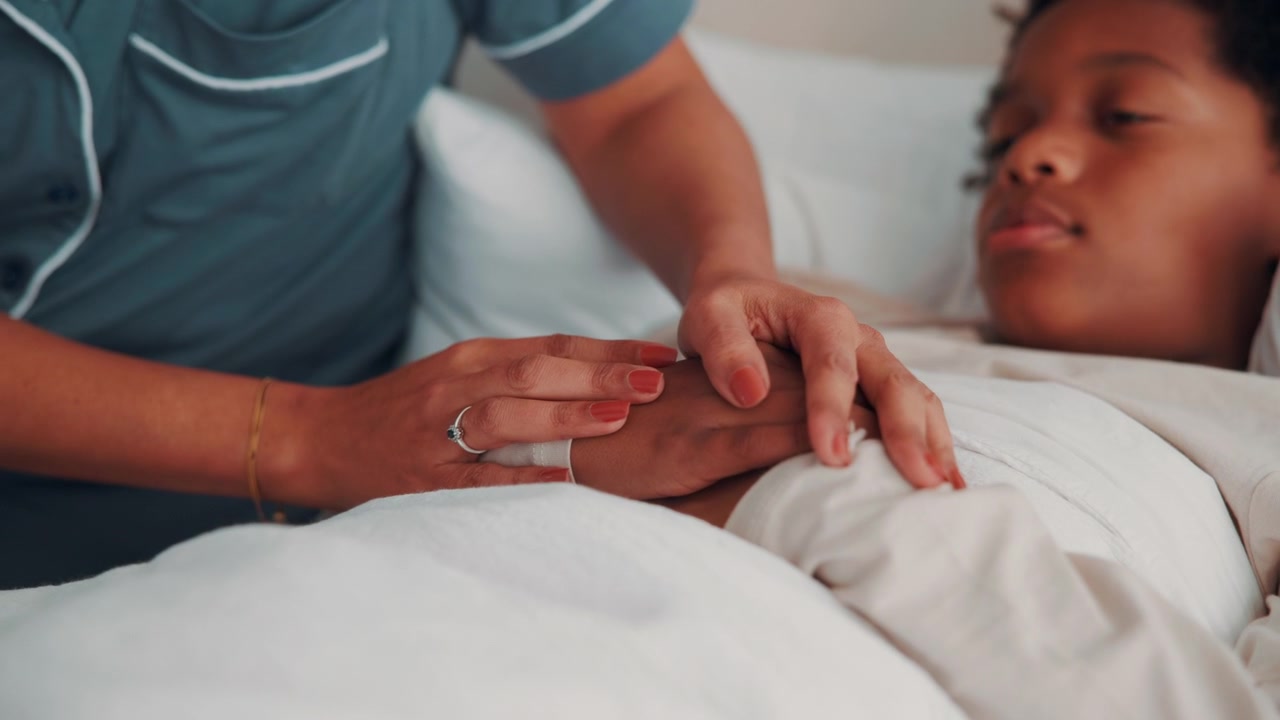 Nurse Comforting Sick Child in Hospital Bed
