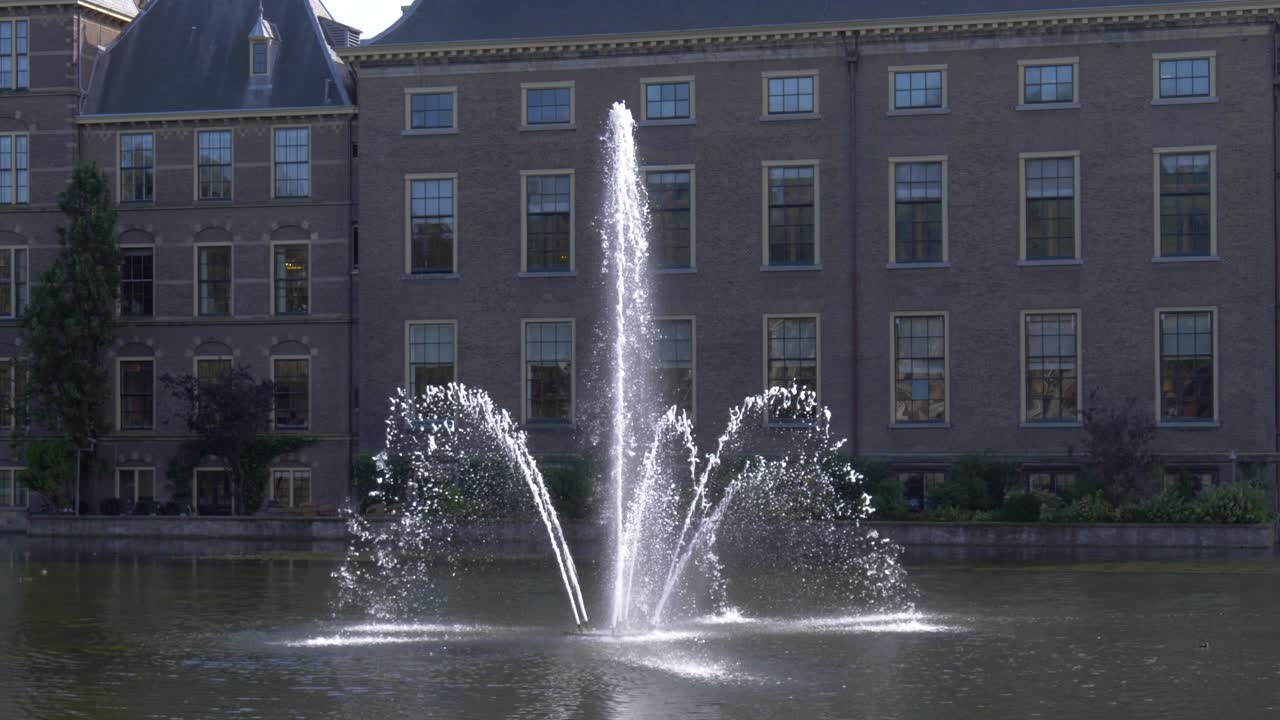 Fountain at the Hofvijer with the Hague Parliament Building in the background in Hague, Netherlands