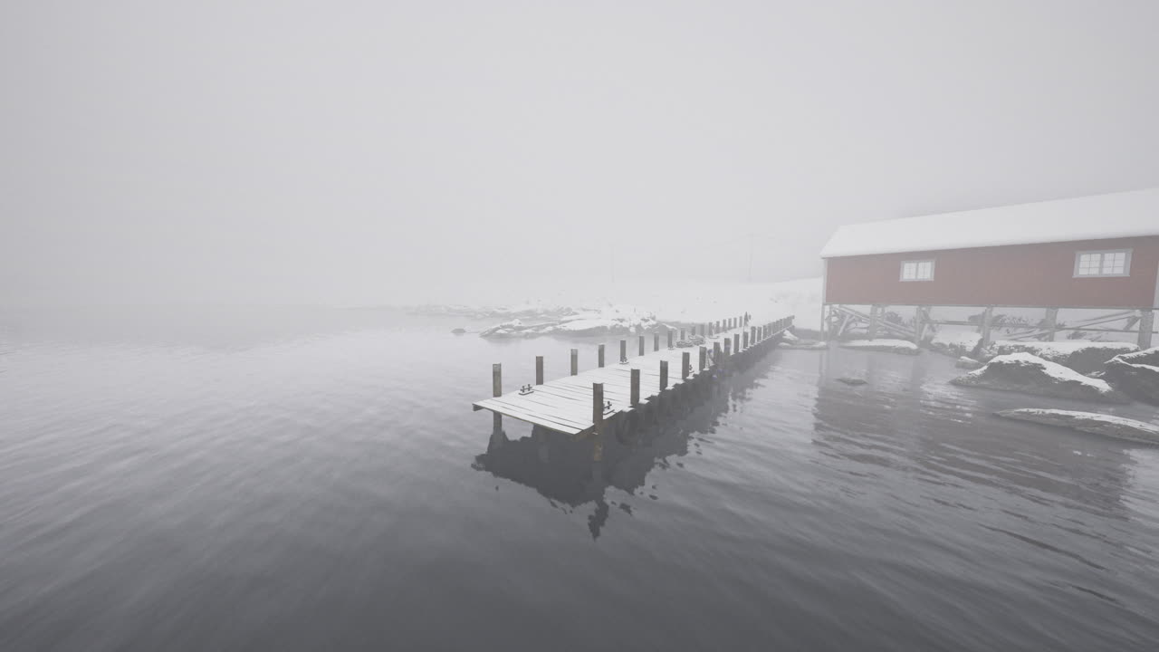 Foggy winter morning at a secluded dock near a snowy cabin