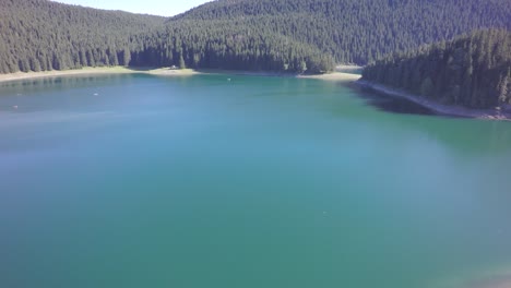 drone footage over clean, green, lake water