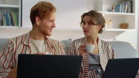 Happy family browsing internet in morning closeup. Smiling couple enjoy coffee