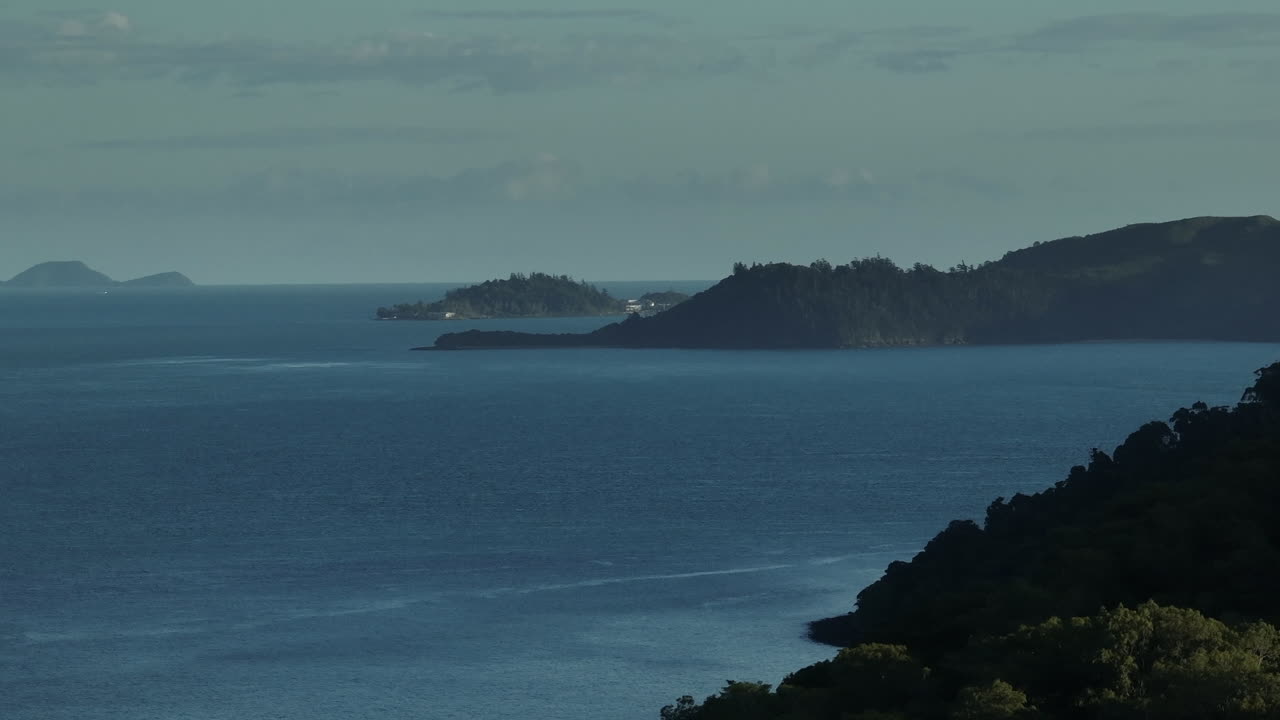 Aerial Drone shot over Long Island with South Molle and Daydream island in the distance at the Whitsundays, Australia