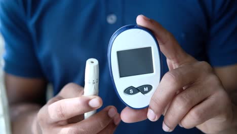 person using a blood glucose meter