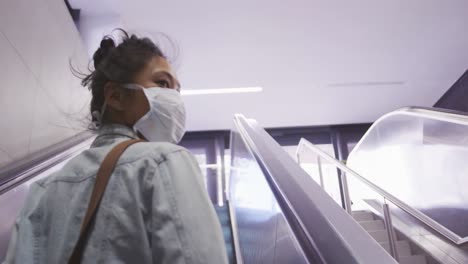 mixed race woman wearing medical coronavirus mask on the street