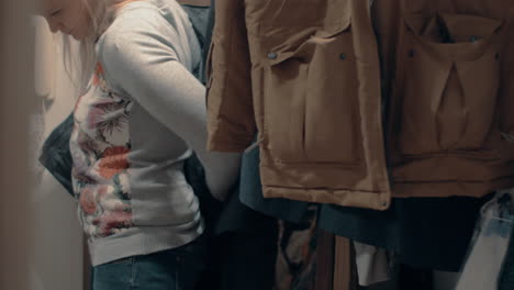 woman putting on jacket before going out