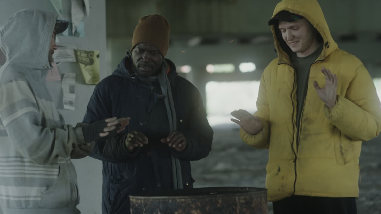 Homeless Men Huddling for Warmth Around a Barrel