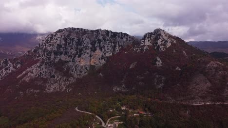 Aerial-forward-view-of-Pietroroja-massif-under-cloudy-sky