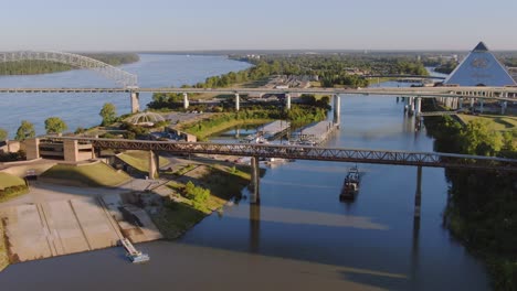 barge passing under bridge - low altitude aerial view