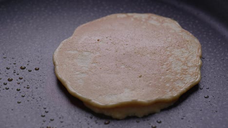 turning a pancake over while cooking breakfast