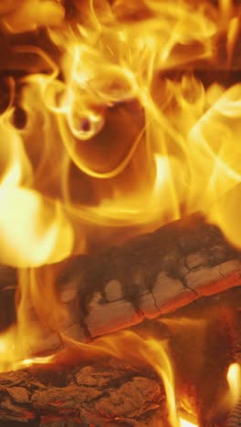 Vertical-Video-Close-Up-Flames-Fire-Logs-In-Wood-Burning-Stove-At-Home-5