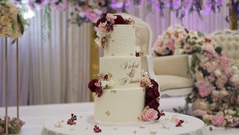 a detailed shot of the elegantly decorated wedding cake in the venue hall.