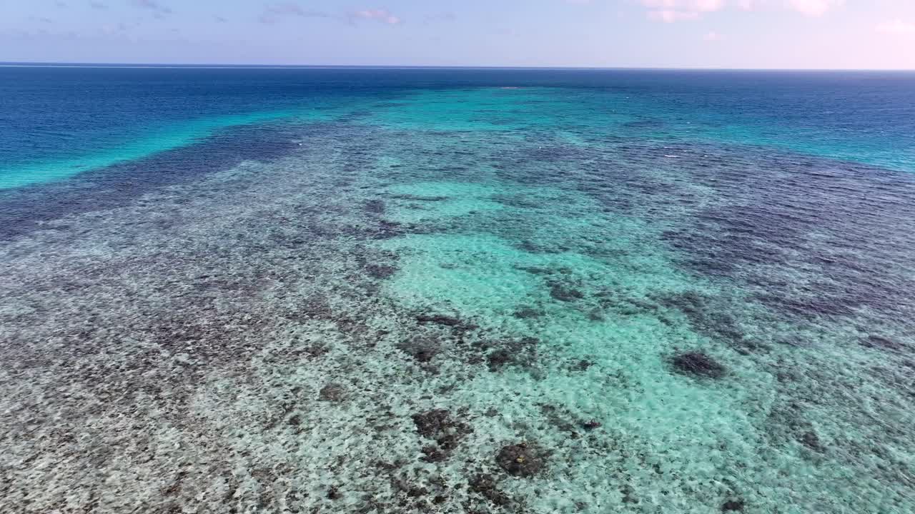 Summer Scenery Of Coral Reef Seen Through Turquoise Sea In Tropical Island. aerial drone