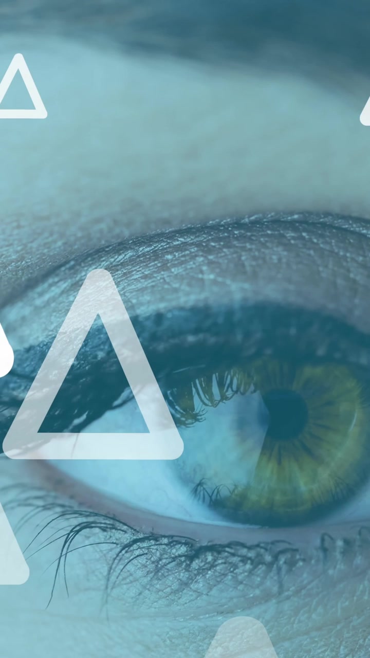 Animation of white triangles flying up over woman's eye