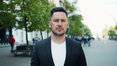 man in a business suit on a city street