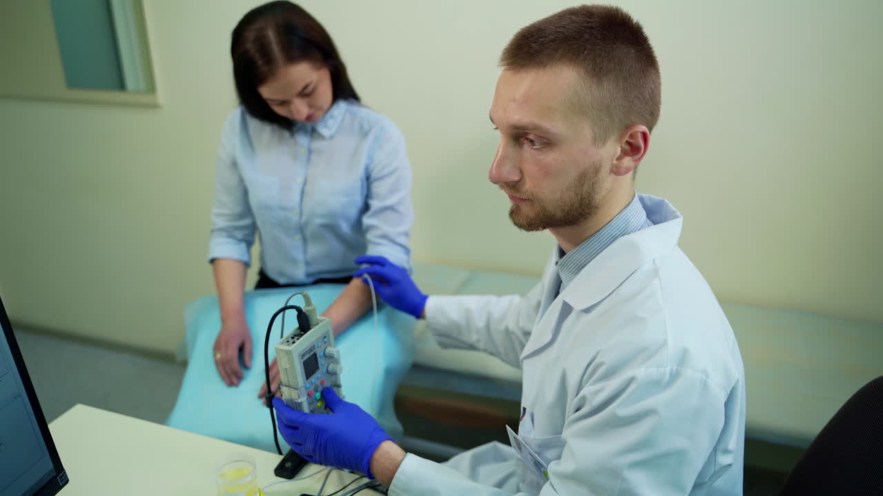 Physician treating young woman. Portrait of young doctor examining patient health