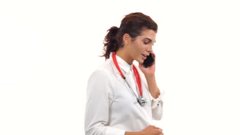 Portrait-of-a-young-doctor-talking-on-the-mobile-phone-and-walking.-Young-medical-professional-with-stethoscope-and-lab-coat-isolated-on-white-background
